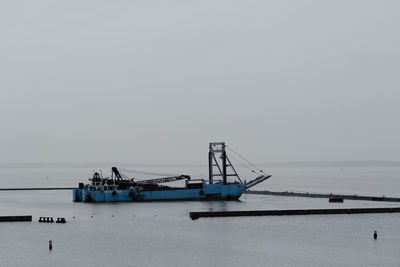 Ship in sea against clear sky