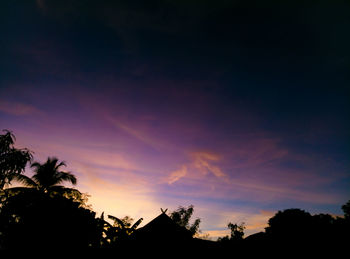 Low angle view of silhouette trees against sky at sunset