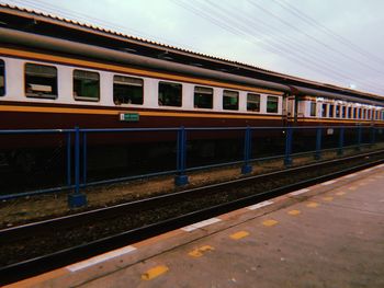 Train at railroad station against sky