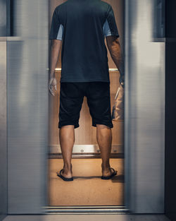 Low section of man walking in corridor