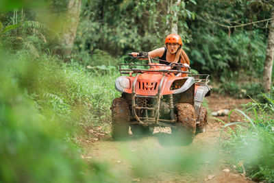 Rear view of man standing in forest