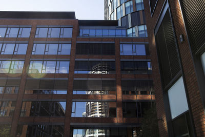 Low angle view of modern buildings against sky