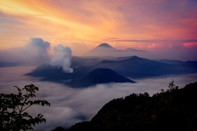 Scenic view of volcanic mountain against sky during sunset