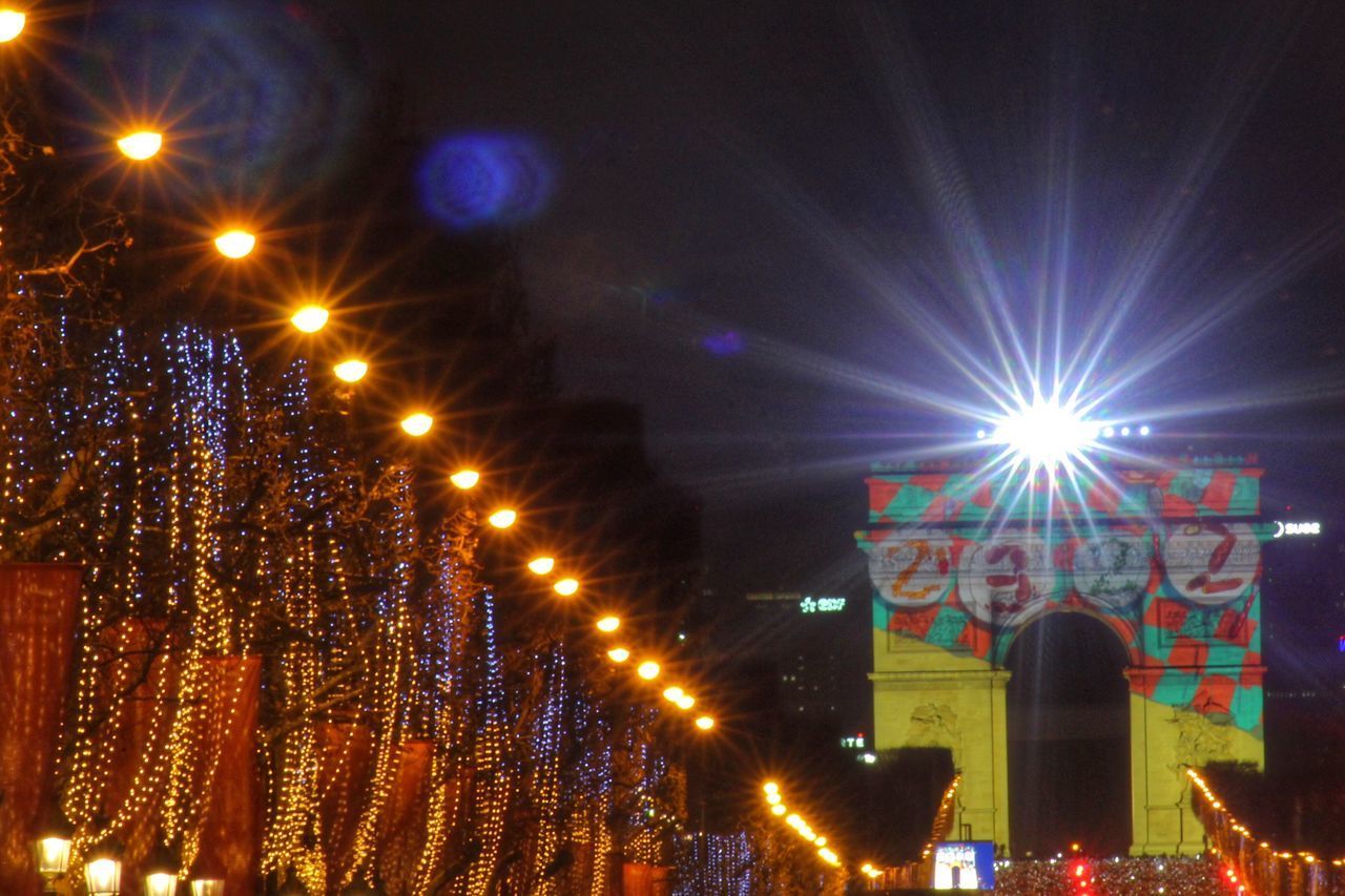 LOW ANGLE VIEW OF ILLUMINATED LIGHTS AT NIGHT