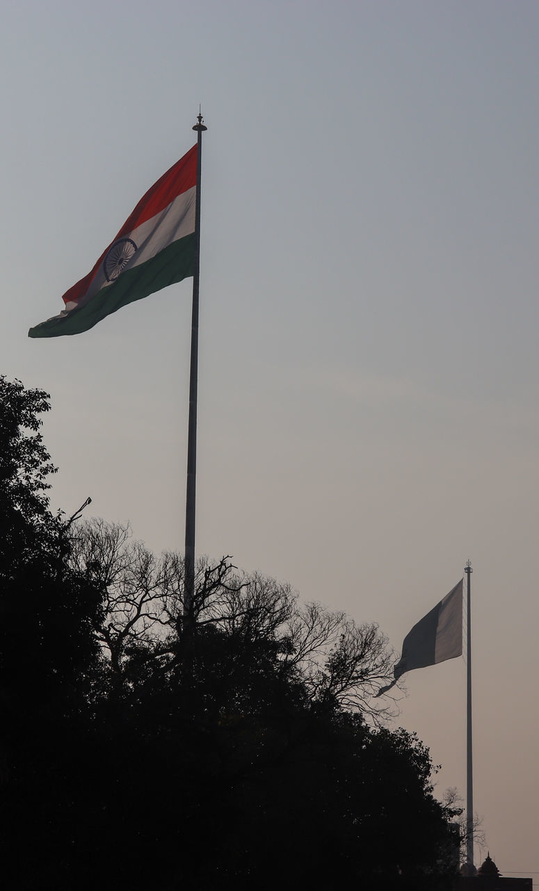 LOW ANGLE VIEW OF FLAGS AT DUSK