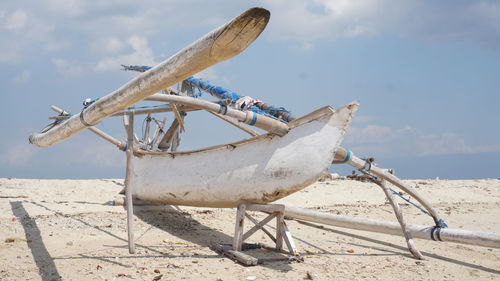 Low angle view of boat on beach against sky