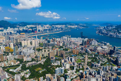 High angle view of city by sea against sky