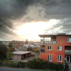 Buildings against cloudy sky