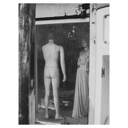 Rear view of shirtless man standing by window