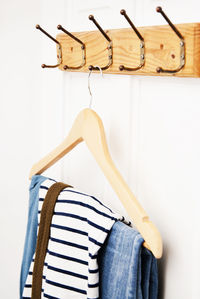 Close-up of clothes hanging on hook against wall