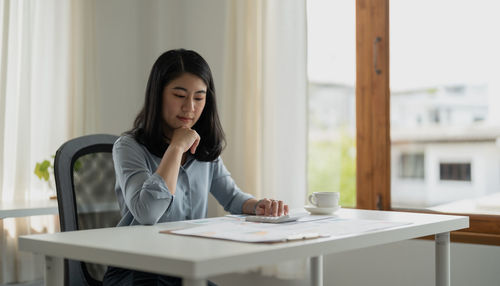 Portrait of young businesswoman working at office