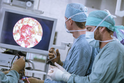 Neurosurgeons in scrubs during an operation
