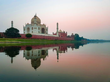 Reflection of building in lake at sunset