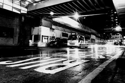 Illuminated city street during rainy season at night