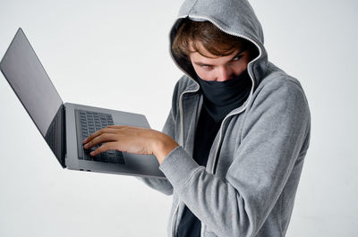 Young woman using laptop at table