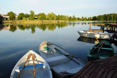 Boats moored in calm lake