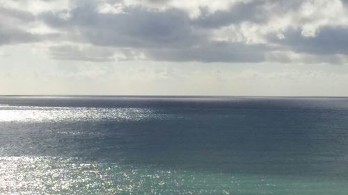 Scenic view of sea against cloudy sky