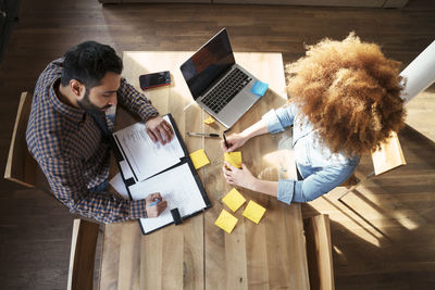 High angle view of business people working at table in office