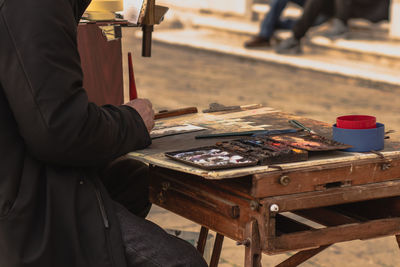 Midsection of man working at table