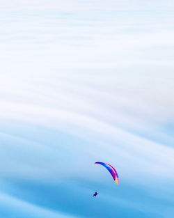 Low angle view of person paragliding against sky