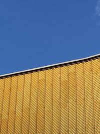 Low angle view of modern building against clear blue sky ukraine colors 