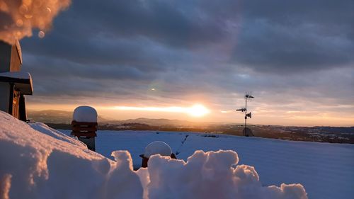Panoramic view of snow against sky during sunset