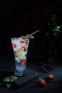View of drink on table against black background