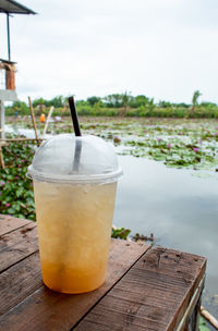 Close-up of drink on table against sky