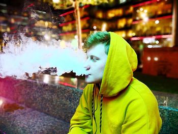 Man exhaling smoke in bar