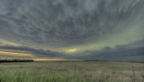 Scenic view of storm clouds over landscape