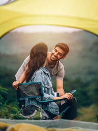 Young couple sitting outdoors