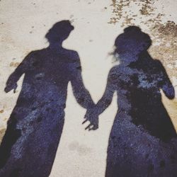 Shadow of couple on sand