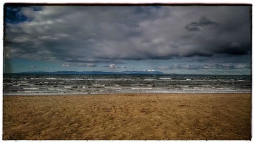 Scenic view of sea against cloudy sky