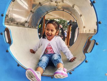 Smiling girl enjoying in slide