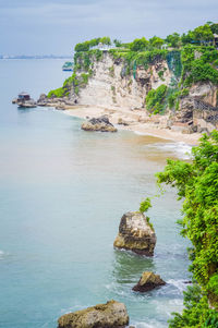 Rock formations by sea against sky