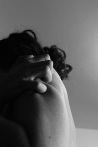 Close-up of woman hand on wall at home