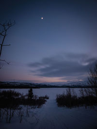 Scenic view of lake against sky at night