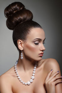 Close-up of beautiful fashion model against gray background