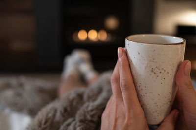 Close-up of hand holding coffee cup