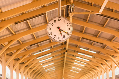 Low angle view of clock on ceiling