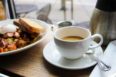 Close-up of coffee with breakfast on table