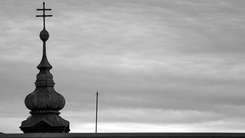 High section of a building against cloudy sky