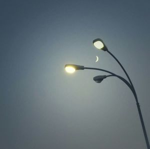 Low angle view of street light against sky