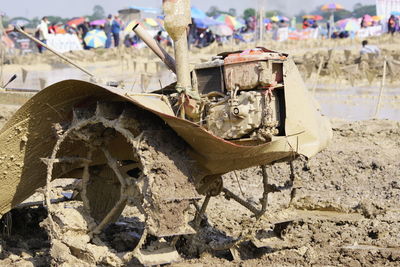 Close-up of abandoned motorcycle on field