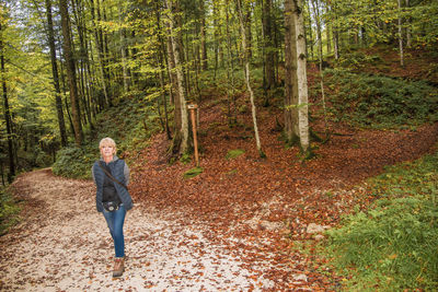 Full length of man walking in forest