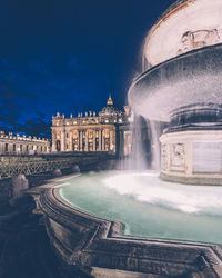 Fountain in city at night