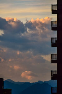 Low angle view of silhouette buildings against sky at sunset