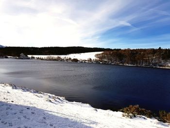 Scenic view of frozen lake against sky during winter