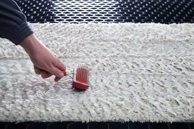 Close-up of woman holding umbrella on rug