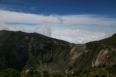 Volcanic landscape on the top of the crater with clouds at the irazú volcano national park